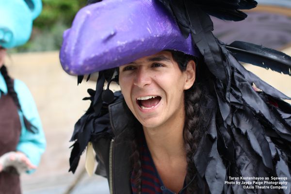 A young theatre performer wearing a bird costume