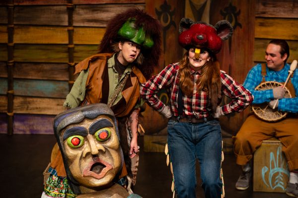 Three actors dressed in period costumes