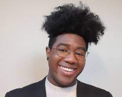 A young man smiling at the camera