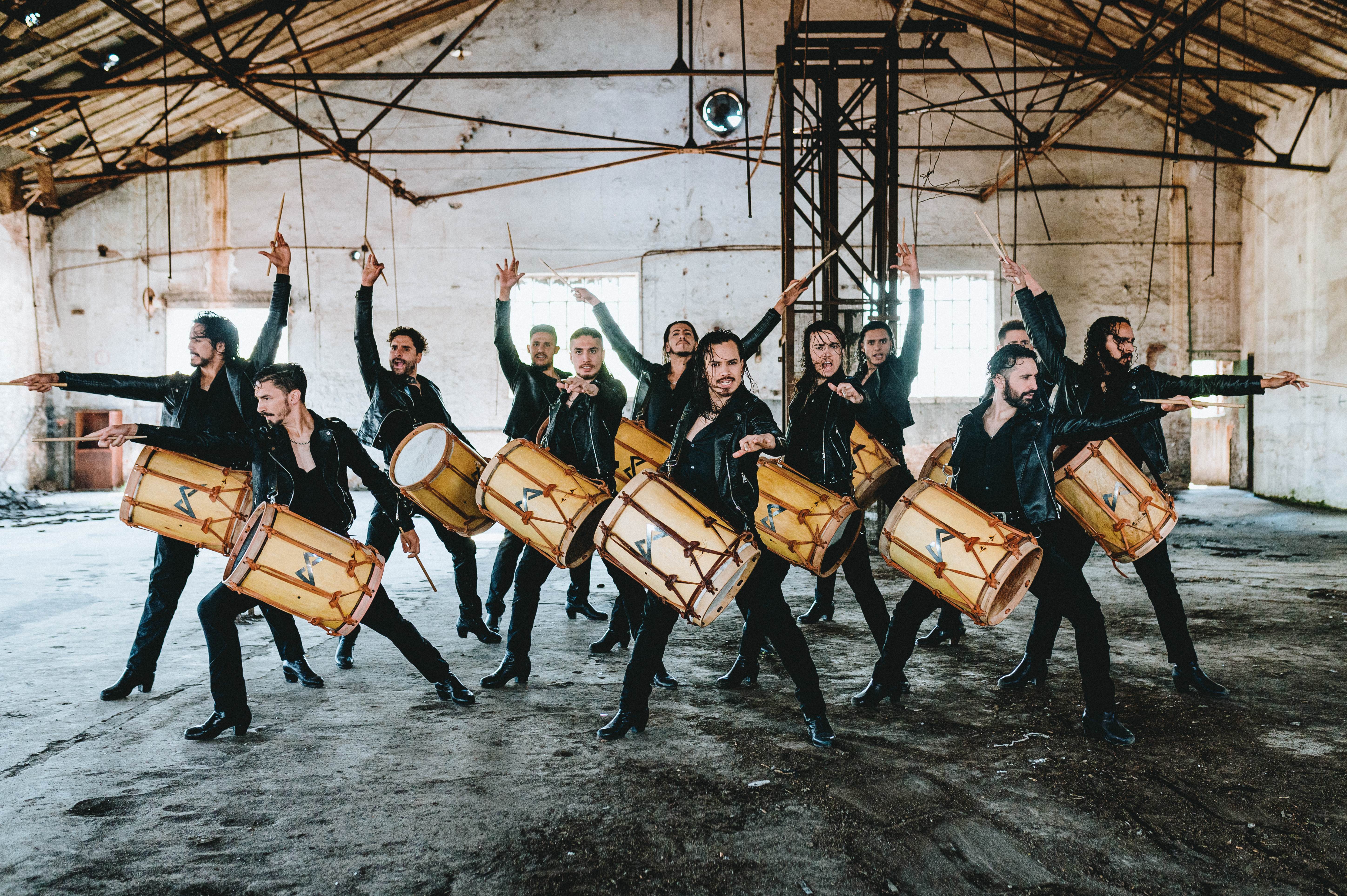 all male drummers with their hands in the air