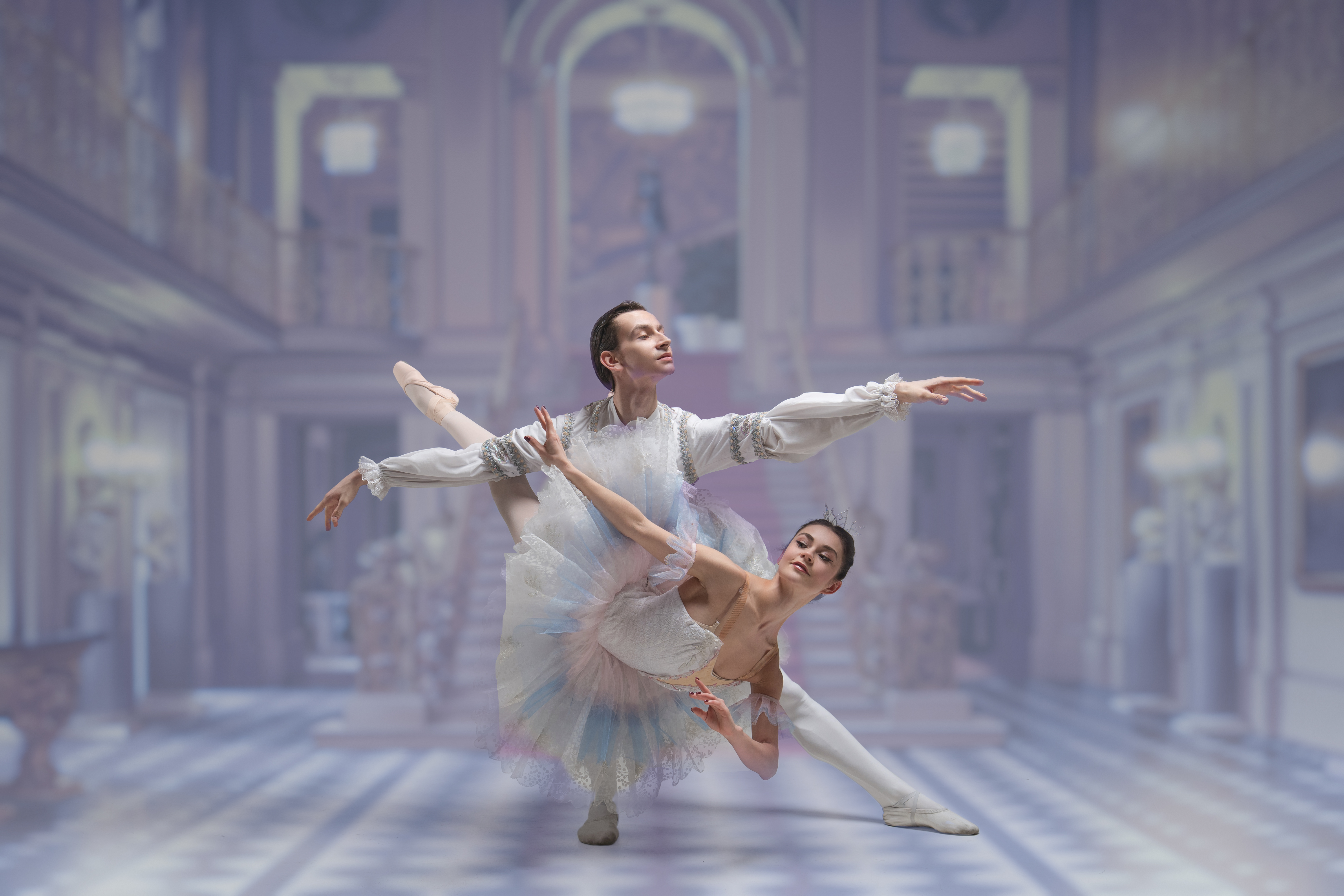 multiple dancers on stage, some with their arms in the air