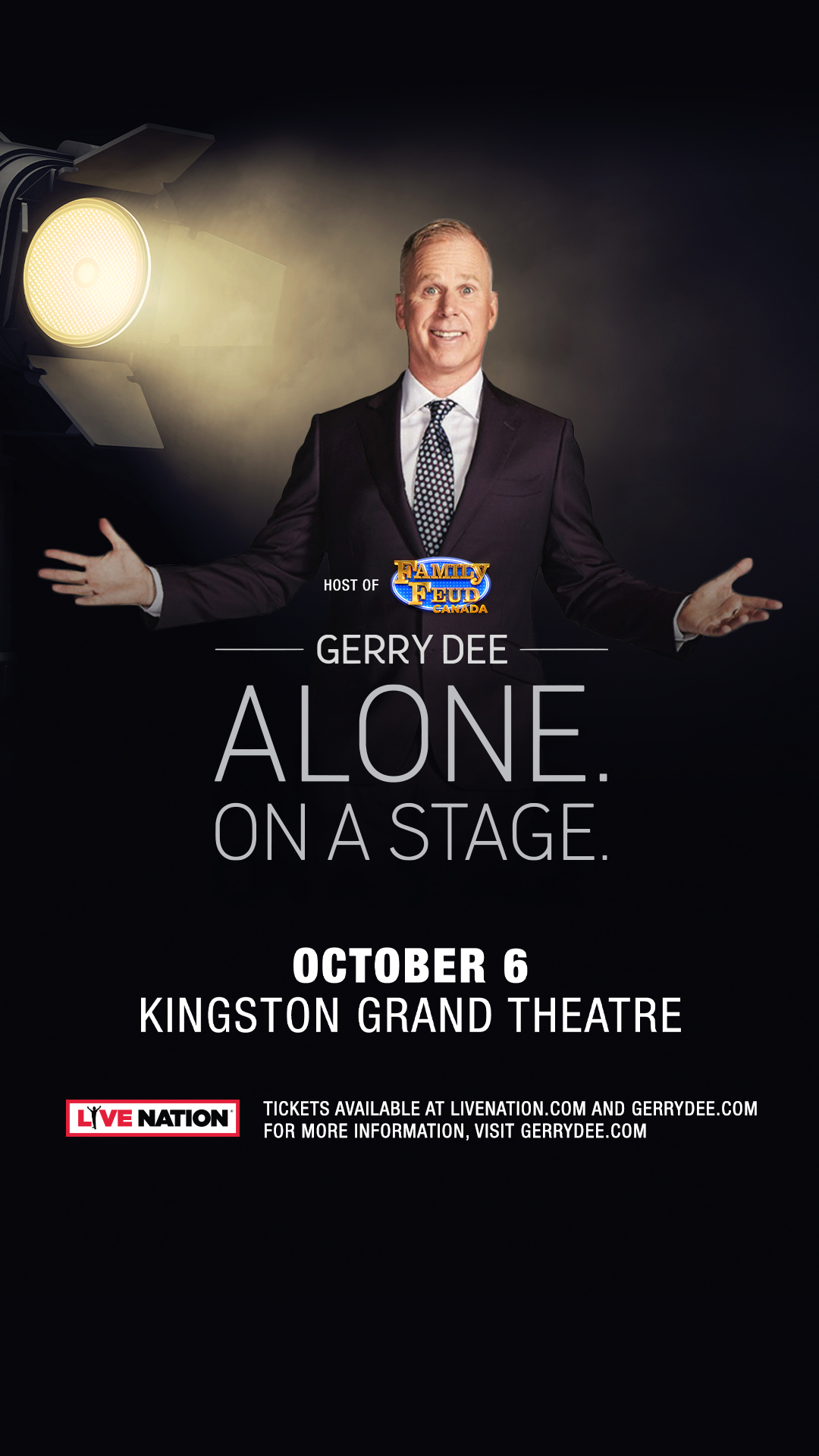 Gerry Dee. Alone. On A Stage Gerry Dee, hands spread wide on a stage with spotlight in top right corner