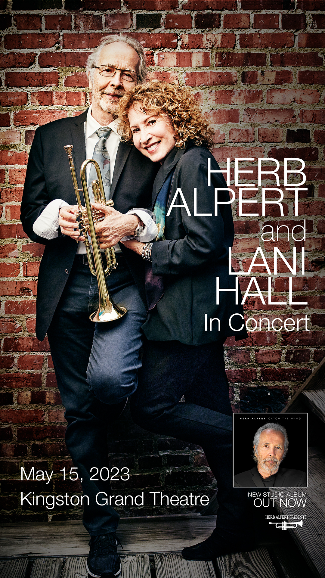Herb Alpert & Lani Hall Herb and Lani snuggled together in front of a red brick wall