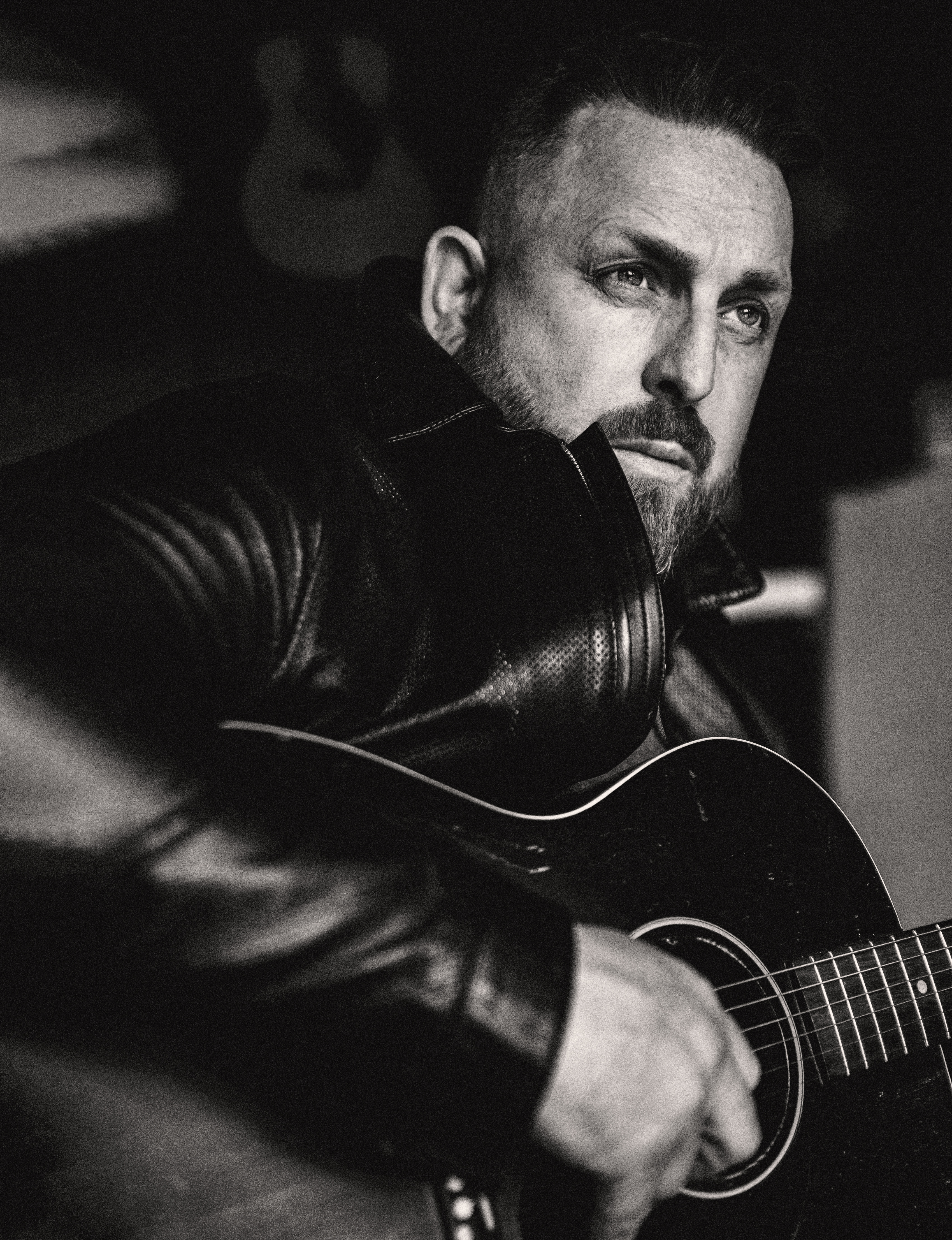 Johnny Reid black and white image with a guitar