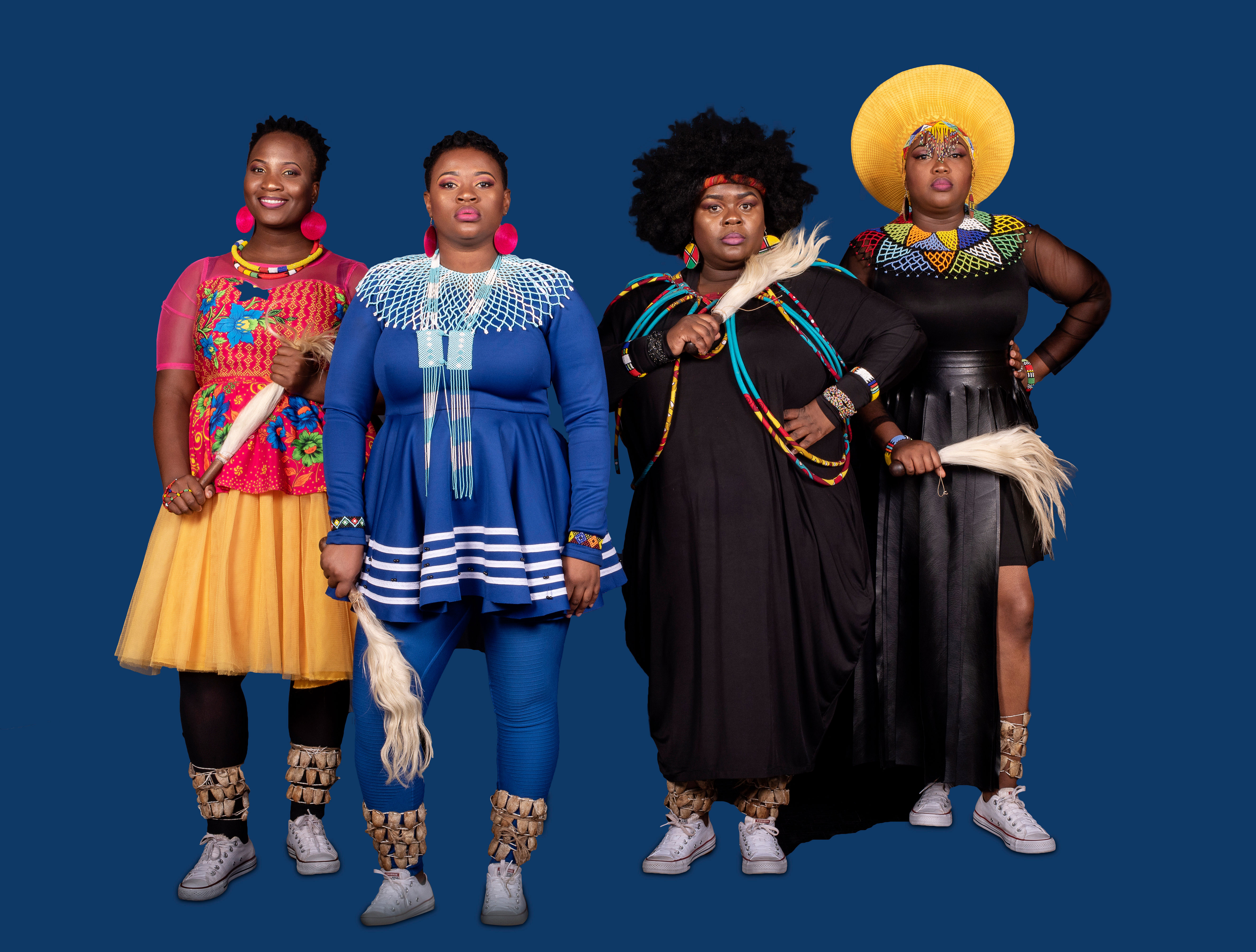 Four members of Nobuntu wearing performance clothing and looking at camera.