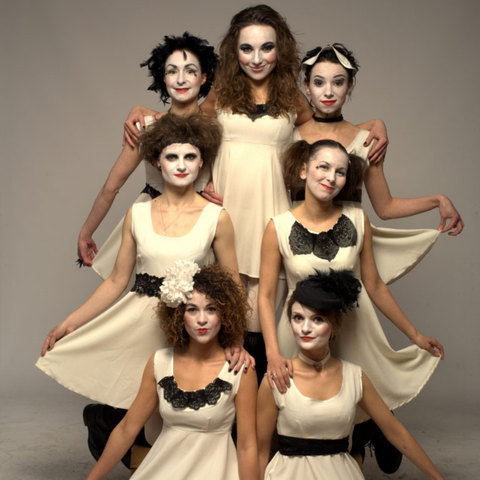 Dakh Daughters all in ivory dresses poised looking at the camera