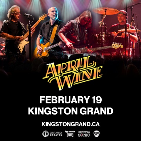 Rock band April Wine performing on stage under colorful spotlights, with guitars and drums visible and the band’s logo displayed at the bottom.