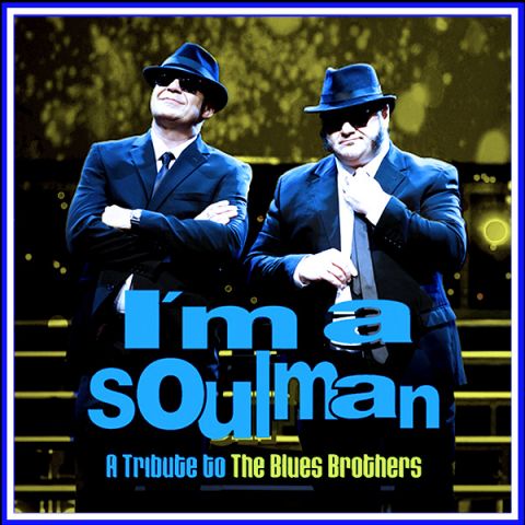 two males dressed in blue suits with hats and sunglasses