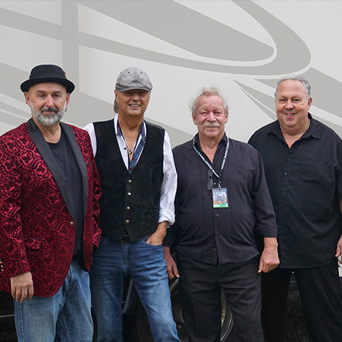members of Downchild Blues band standing infront of their tour bus