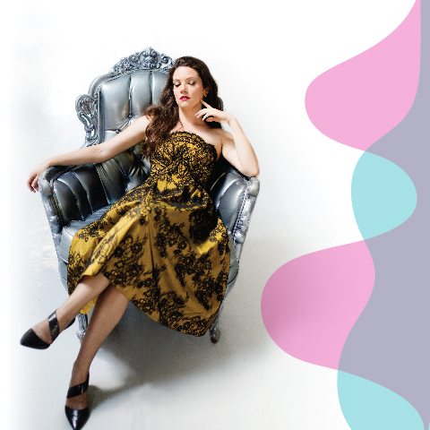 brunette in a gold dress, lounging in a chair