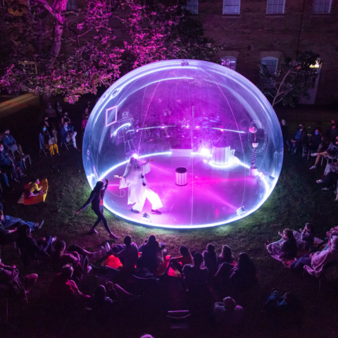 illuminated bubble with actor center stage