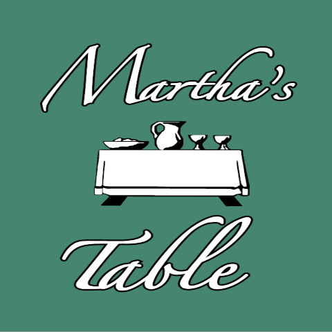 green background with white text stating Martha's Table and a white set table