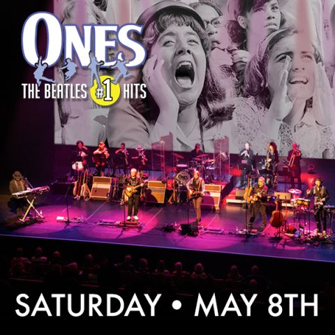 ONES: The Beatles’ #1 Hits tribute band performing live on stage beneath a large backdrop of Beatles fans; Saturday, May 8.