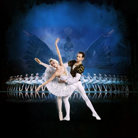 a row of ballet dancers with a pair of dancers up front and center in white