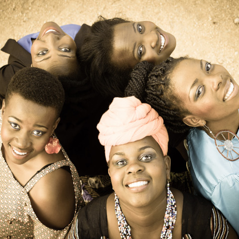 Members looking up at the camera in a circle