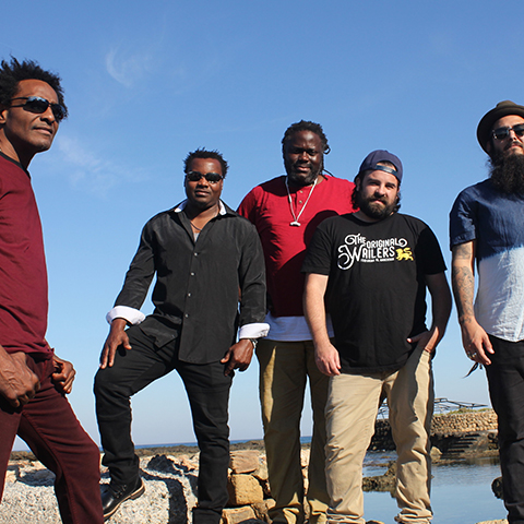 The band stood in front of a body of water