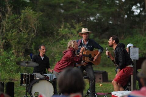 Out of the Woods, 2019 (photo: Kingston Theatre Alliance) An outdoor performance featuring a woman and man singing to each other accompanied by a guitar player and drums