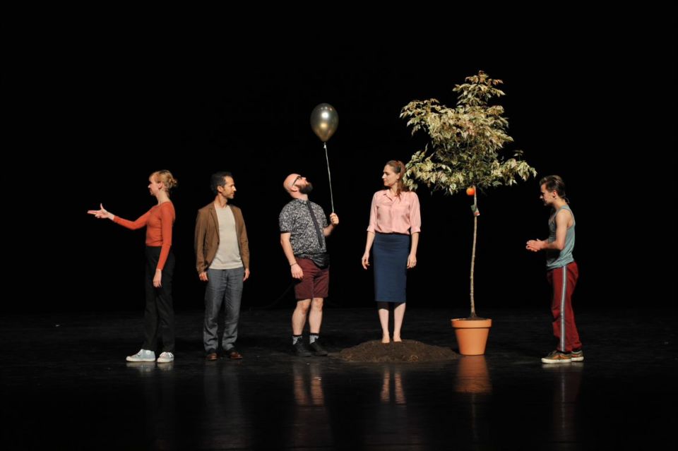 A group of actors standing on a stage