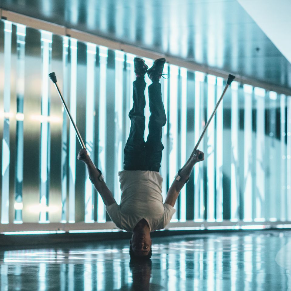 Dancer with crutches balancing on his head Dancer with crutches balancing on his head