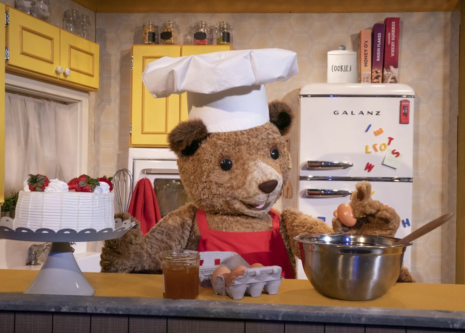 Paddington bear stirring a pot in the kitchen