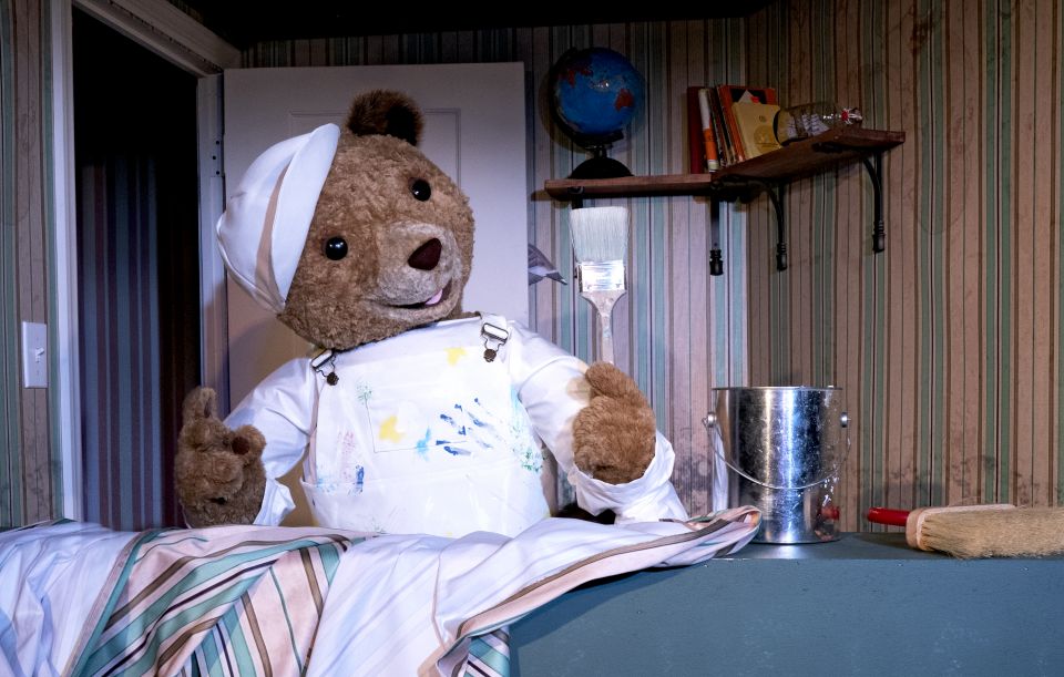 Paddington bear holding a paintbrush