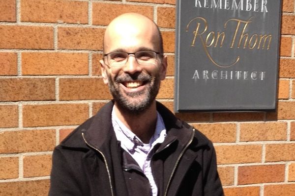 00. The Decisive Moment: Writing Great Scenes Damian Tarnopolsky smiling infront of a red brick wall