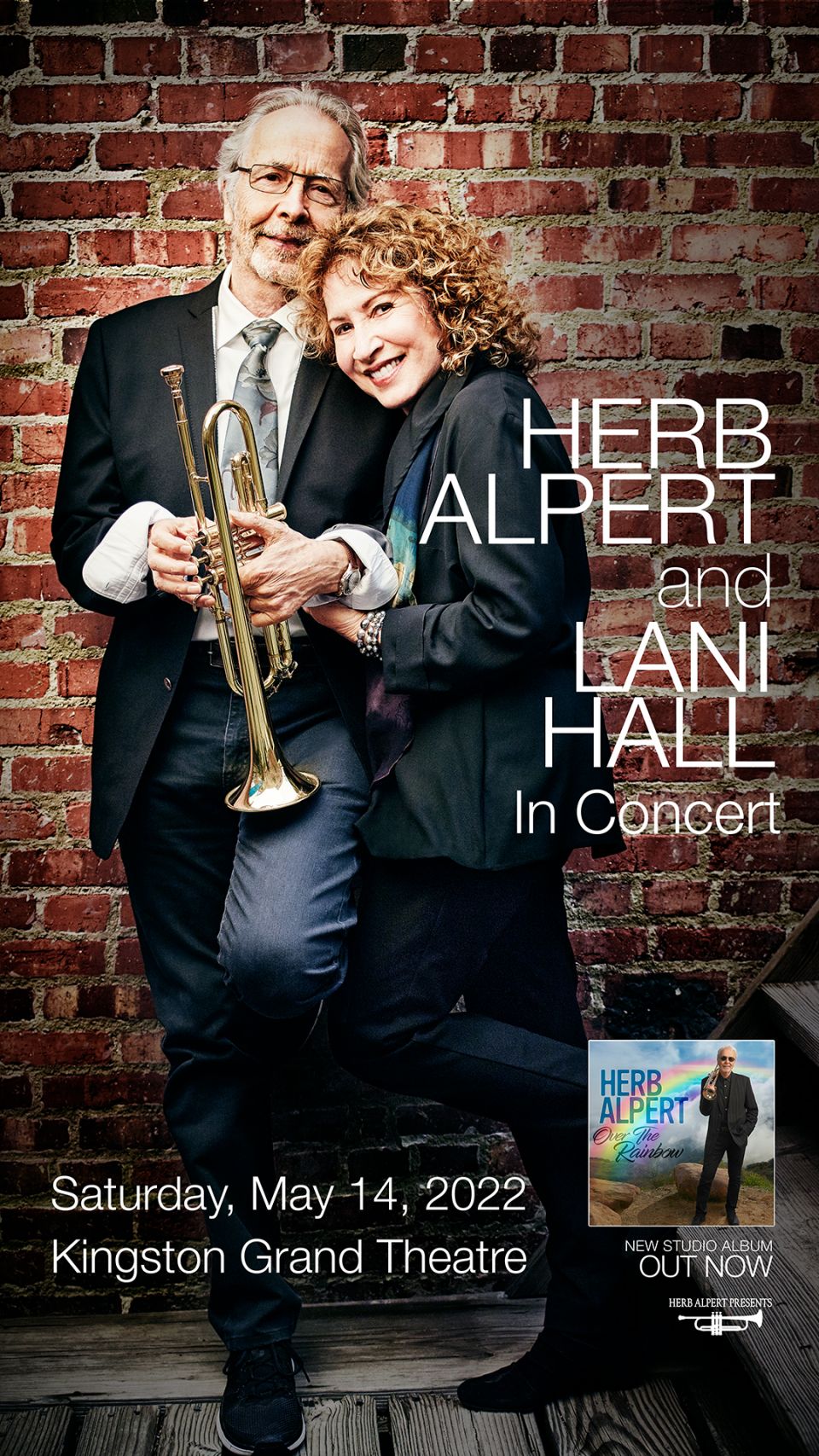 Herb Alpert & Lani Hall Herb and Lani snuggled together in front of a red brick wall
