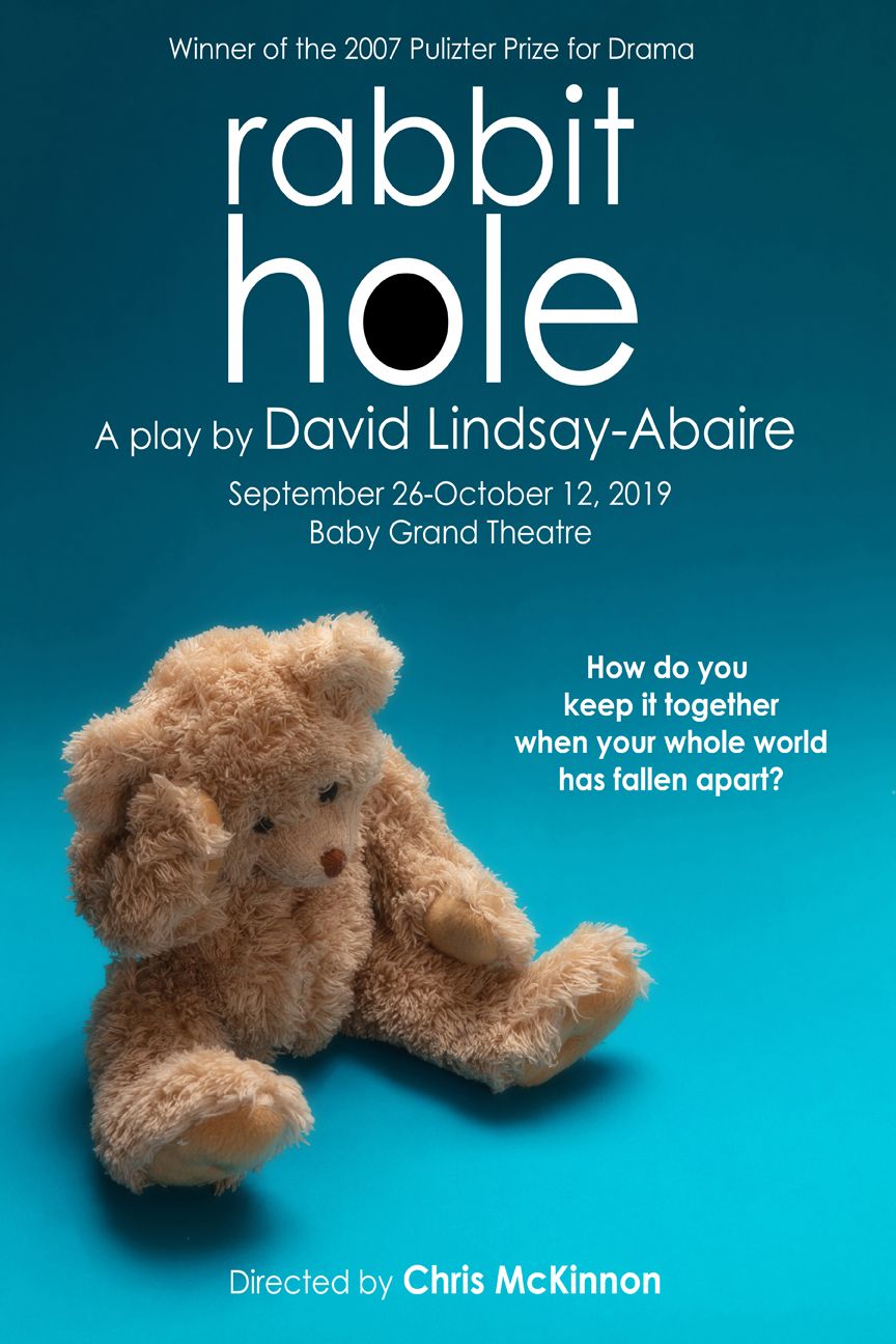 Rabbit Hole a sad looking teddy bear on a blue background