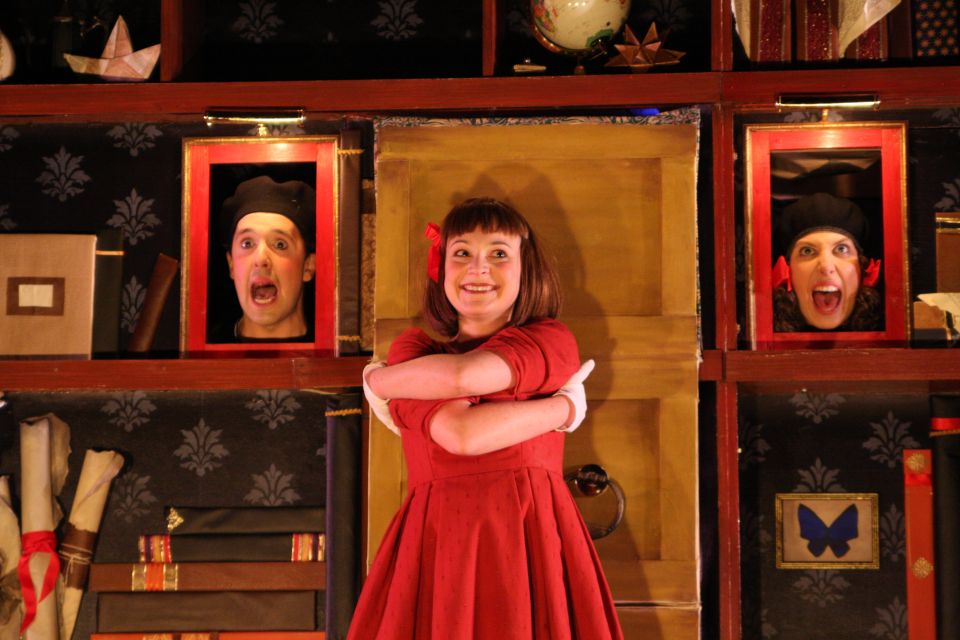 A young girl, Alice in Wonderland, has two faces to her left and right appear to be taking from a bookshelf