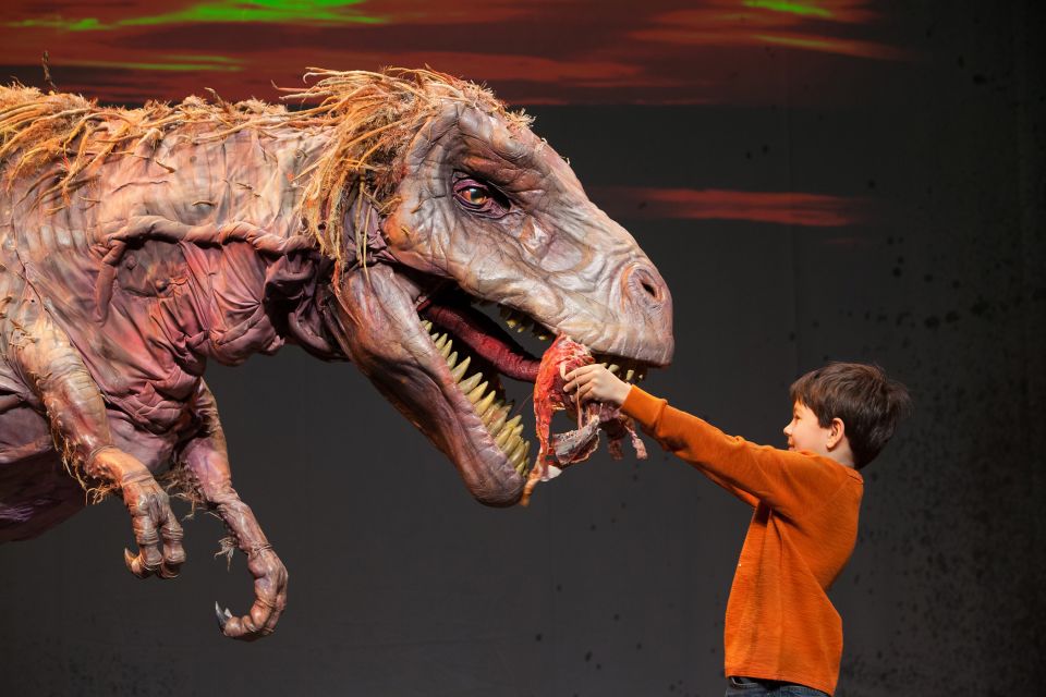 Erth's Dinosaur Zoo A woman with her hands in a dinosaur's mouth