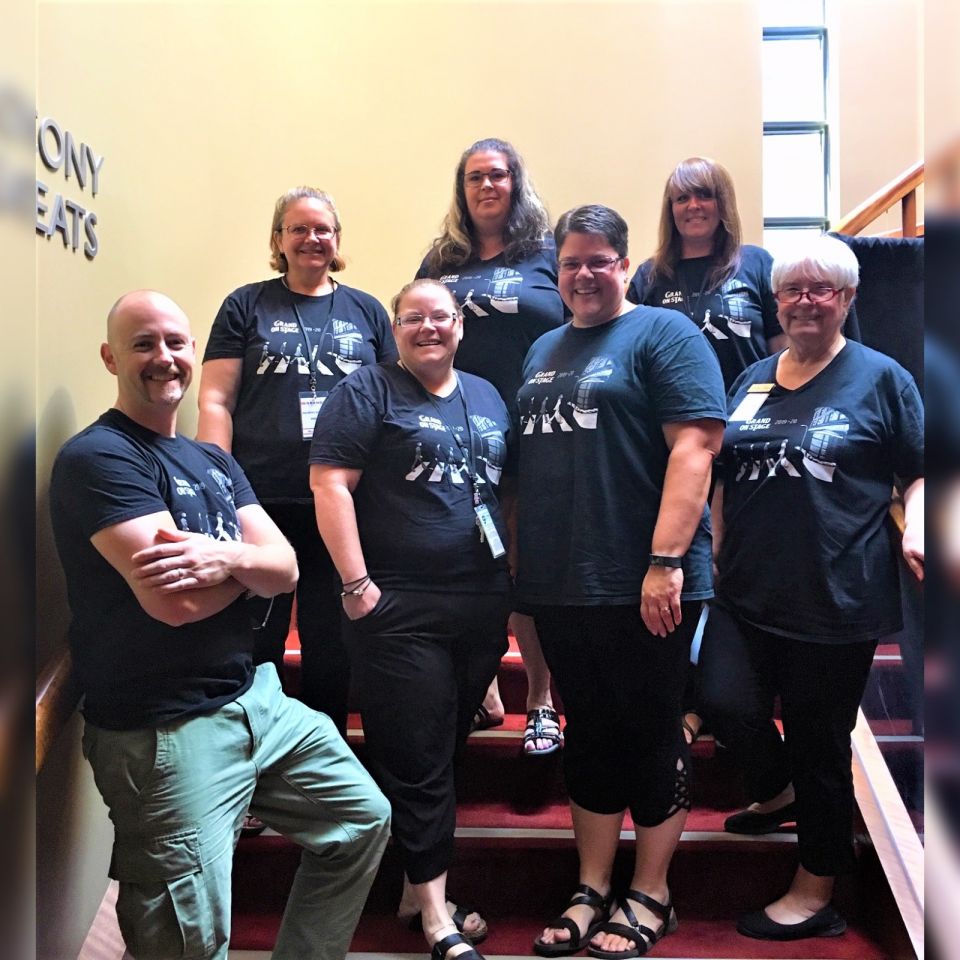Box office staff standing on the stairs in a group
