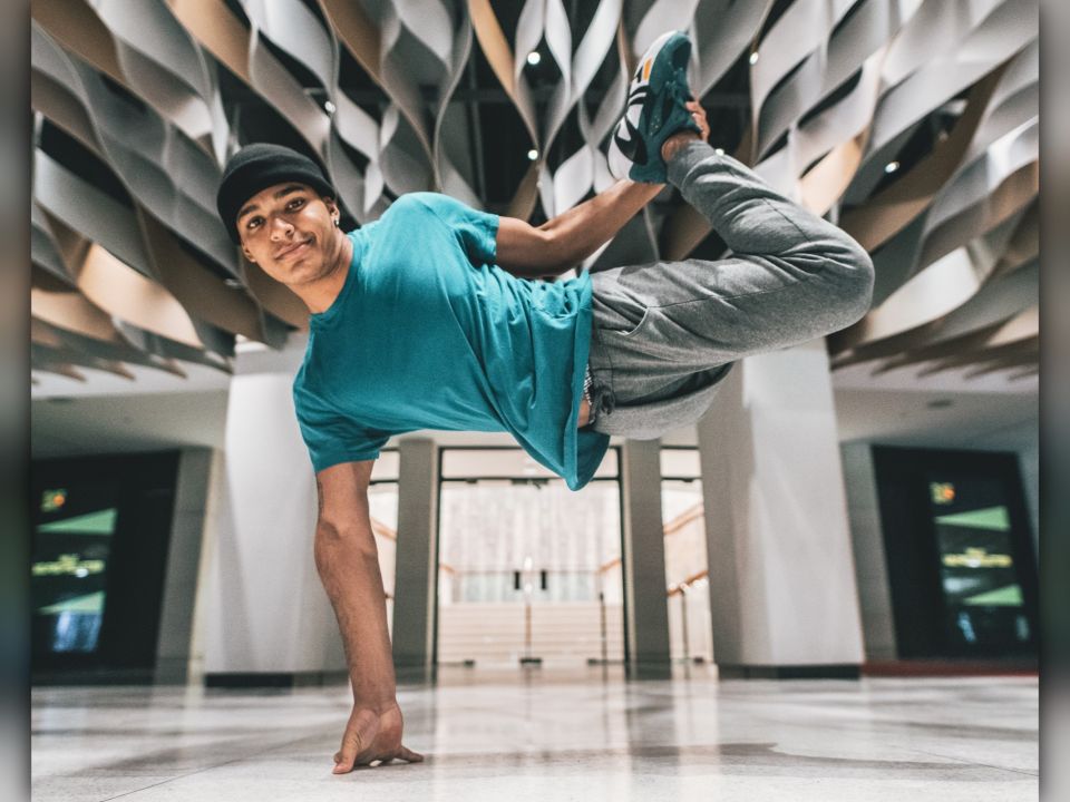 Ill Abilities Youth raised on one arm performing a dance move