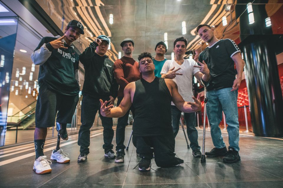 a group of people outside with lights around them posing for the camera
