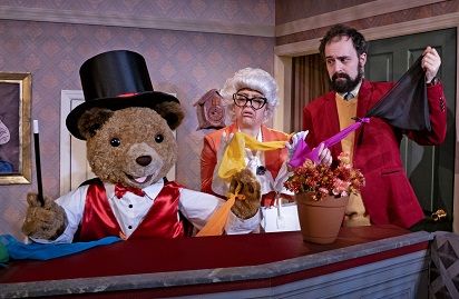 Paddington bear in a magician's costume doing magic