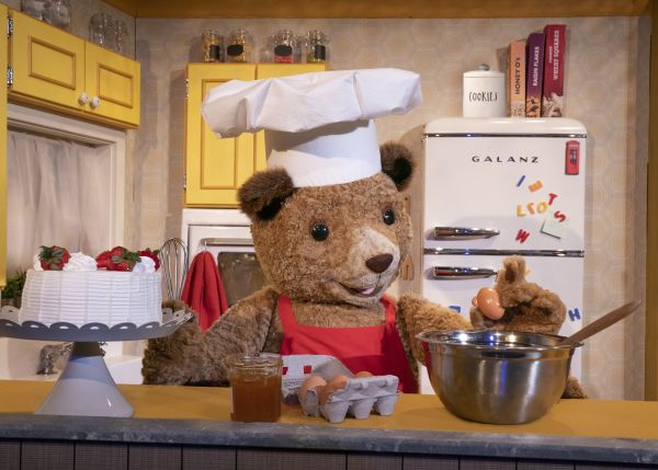 Paddington bear stirring a pot in the kitchen