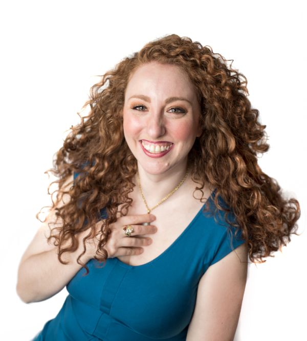 curly red haired lady in a blue shirt