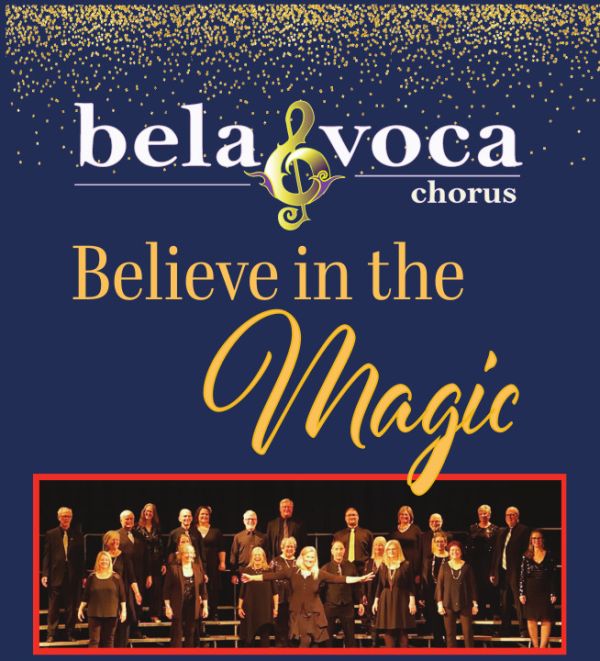 Promotional graphic for Bela Voca Chorus featuring the phrase “Believe in the Magic” in elegant gold lettering on a dark blue background with gold confetti at the top. The Bela Voca logo includes a stylized treble clef. Below the text, there is a photo of a chorus group dressed in black, standing in rows on stage, framed by a red border.