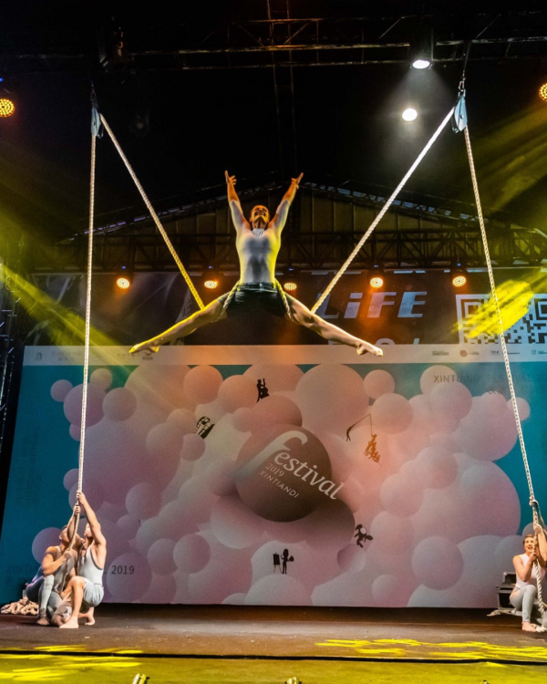 performer pulled in the air by what looks like thread