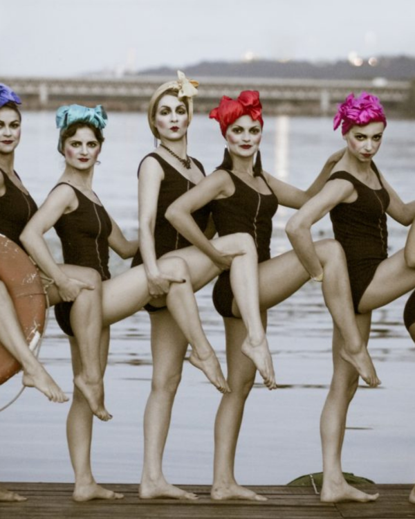 Dakh Daughters poised in black leotards with one leg up