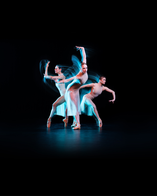 Dancers lite in white arms extended