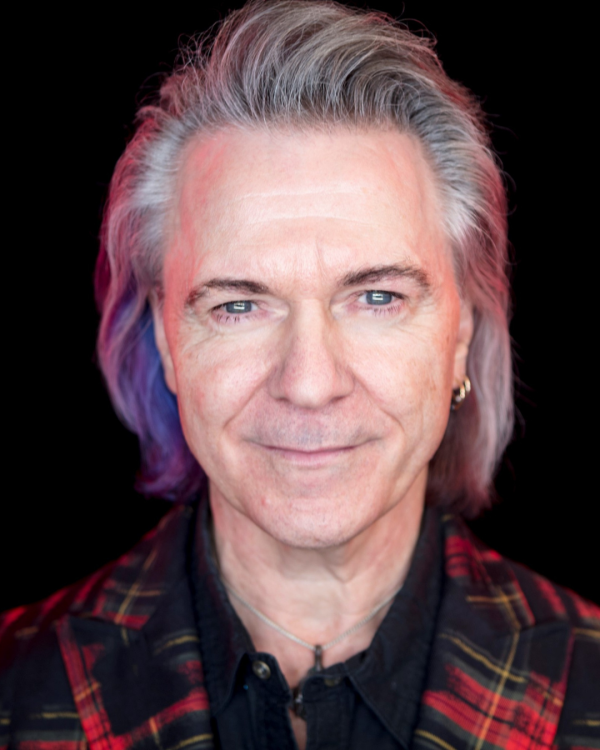 Gowan headshot with him in black on a black backgroun