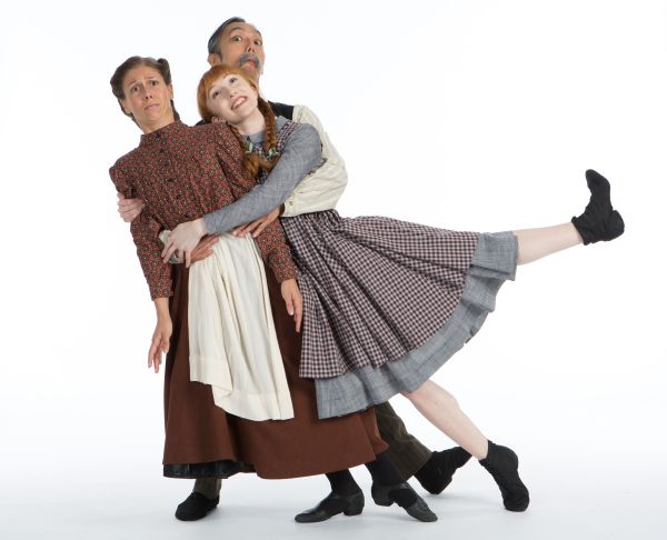 Three cast members embracing