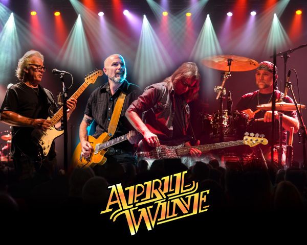 Rock band April Wine performing on stage under colorful spotlights, with guitars and drums visible and the band’s logo displayed at the bottom.