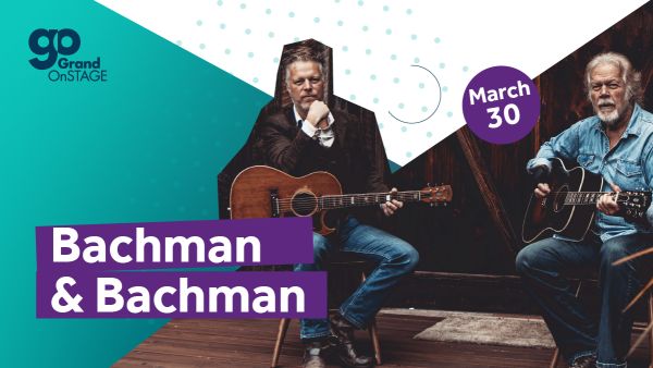 Bachman and Bachman seated with their guitars