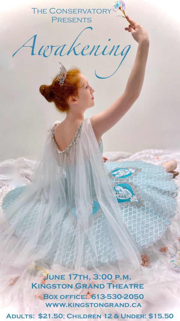 ballerina seated on a bed with her arm raised
