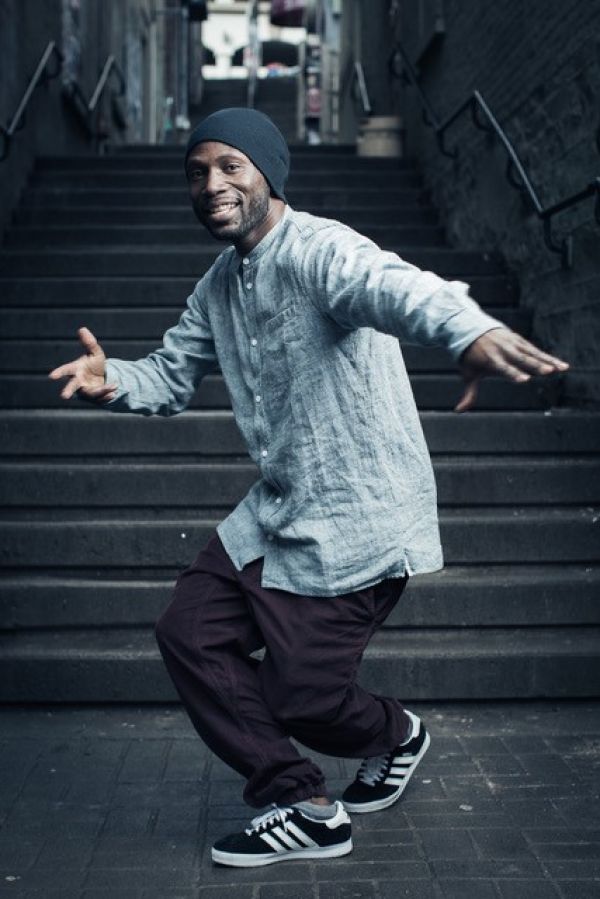 male dancer busting a move in front of a set of stairs