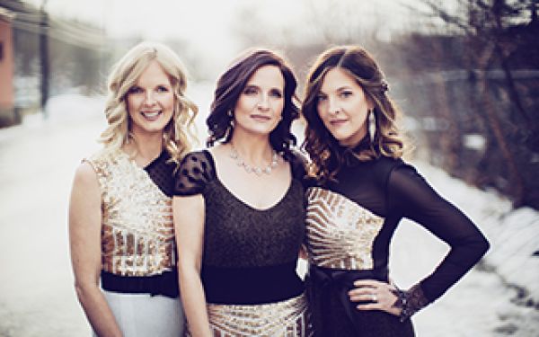 three sisters dressed in black and gold