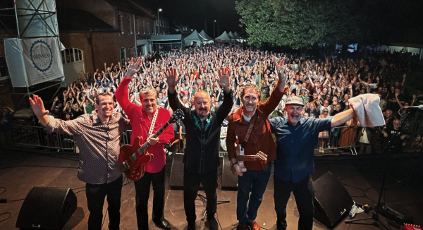 the Fabulous Thunderbirds standing on a stage facing the audience