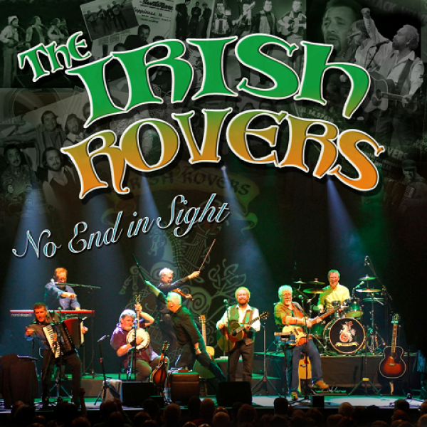 The Irish Rovers, seated on a stage with lights shining down
