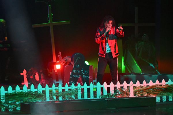 performer in front of a graveyard